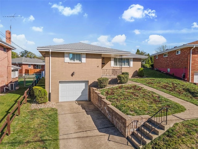 view of front of house featuring driveway, a front yard, a garage, brick siding, and fence