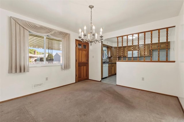 interior space featuring light colored carpet, baseboards, a notable chandelier, and a sink