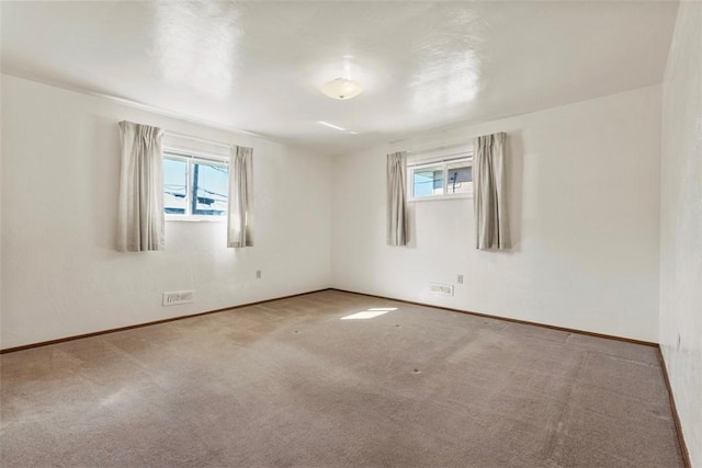 unfurnished room featuring carpet floors and baseboards