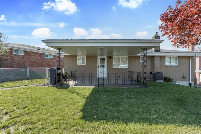 back of house with central AC, fence, a chimney, brick siding, and a patio area