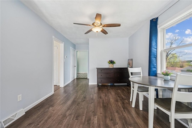 dining space with a ceiling fan, baseboards, visible vents, and wood finished floors