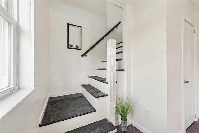 stairs featuring baseboards and wood finished floors