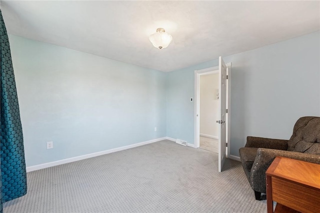 sitting room with baseboards, carpet, and visible vents