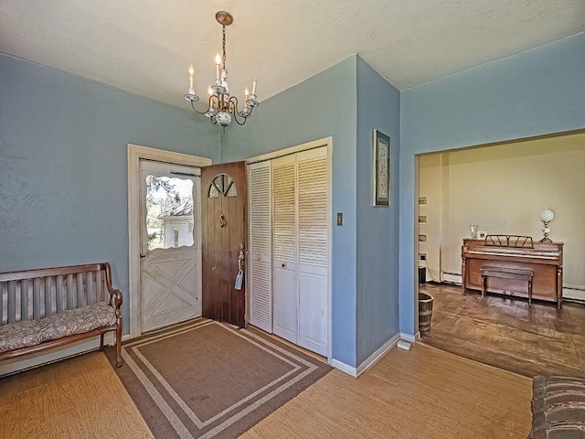 entryway featuring baseboards, a chandelier, wood finished floors, and a baseboard radiator