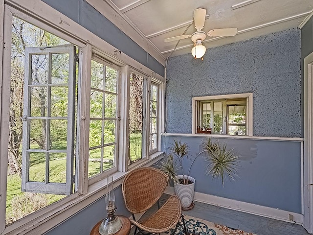 sunroom with baseboards and wood finished floors