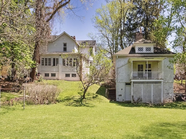 back of property featuring a lawn and a chimney