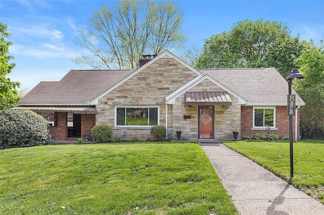 814 Clara St N, Versailles, PA 15137 - view of front of home featuring a shingled roof, stone siding, and a front lawn
