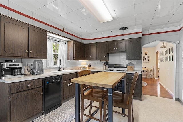 814 Clara St N, Versailles, PA 15137 - kitchen featuring a sink, dishwasher, dark brown cabinetry, and light countertops