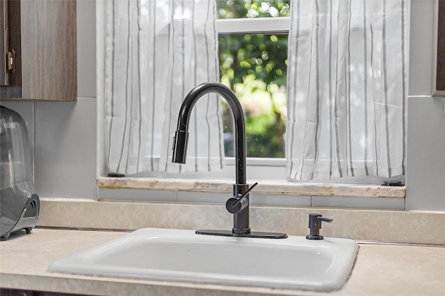 814 Clara St N, Versailles, PA 15137 - interior details featuring a sink, light countertops, and dark brown cabinetry