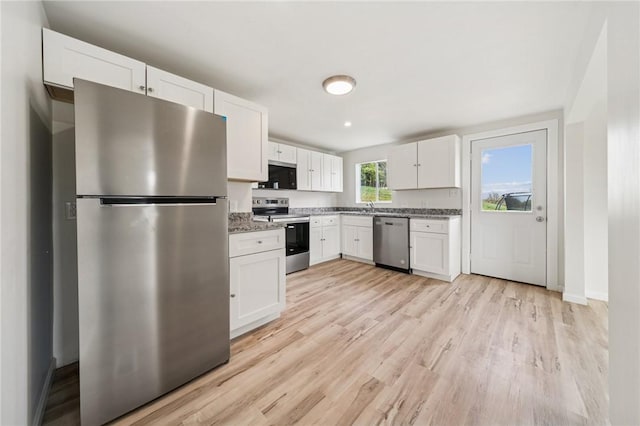 1460 Guffey Rd, North Huntingdon, PA 15642 - kitchen with a sink, appliances with stainless steel finishes, light wood finished floors, and white cabinetry