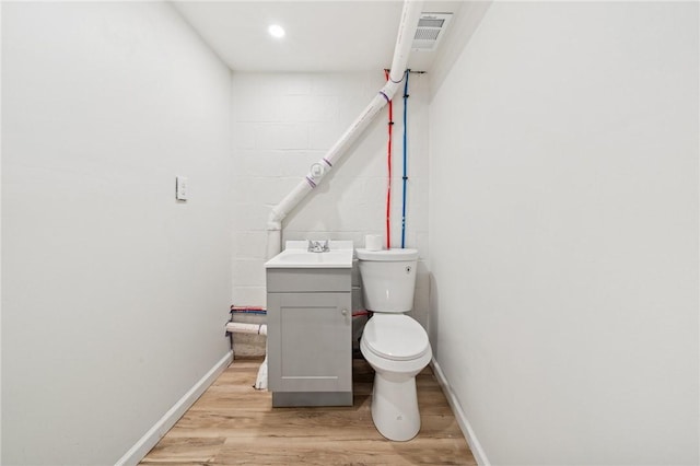 1460 Guffey Rd, North Huntingdon, PA 15642 - half bath featuring baseboards, wood finished floors, toilet, and vanity