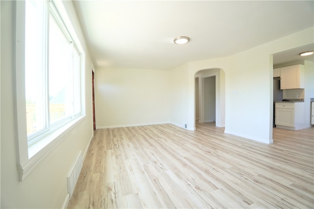 1460 Guffey Rd, North Huntingdon, PA 15642 - spare room with arched walkways, baseboards, light wood-type flooring, and visible vents