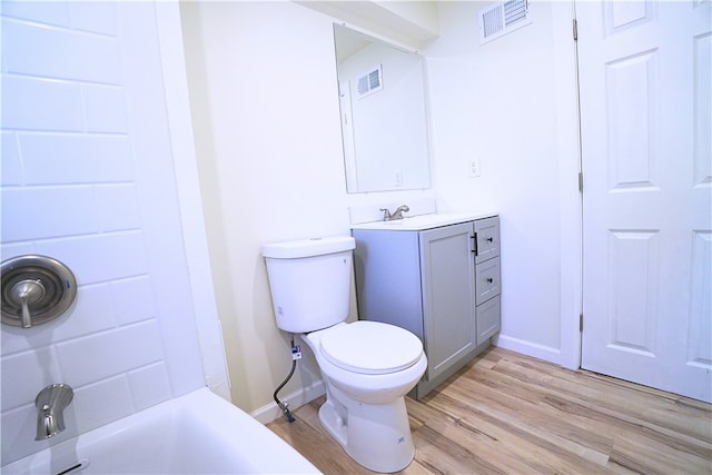 1460 Guffey Rd, North Huntingdon, PA 15642 - full bathroom featuring toilet, baseboards, visible vents, and wood finished floors