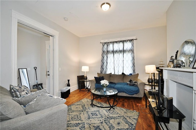 living room with baseboards and wood finished floors
