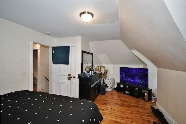 bedroom featuring wood-type flooring and lofted ceiling
