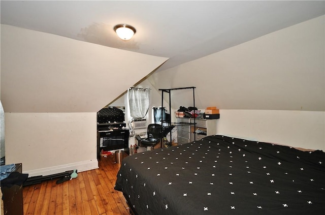 bedroom featuring baseboards and hardwood / wood-style flooring