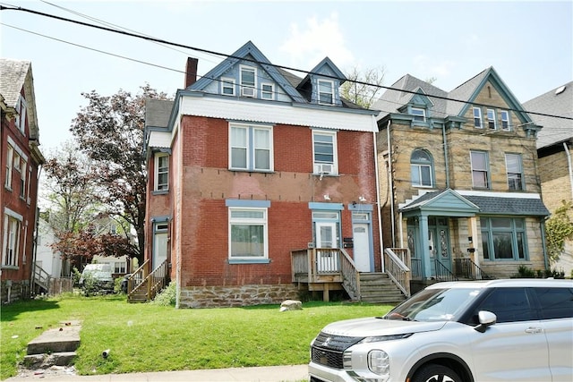 view of front of home with brick siding, a front lawn, and cooling unit