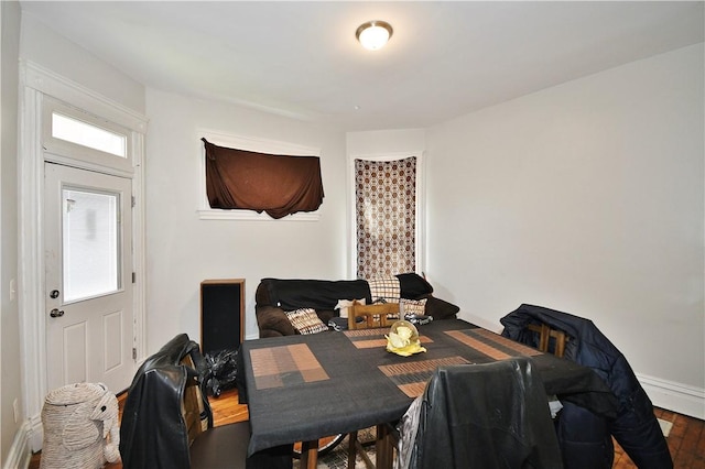 dining area with baseboards and wood finished floors