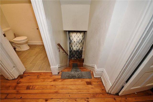 stairs with baseboards and hardwood / wood-style flooring