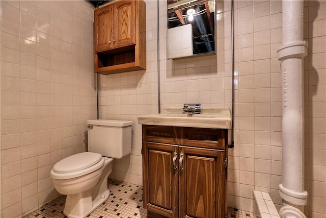 bathroom with tile patterned floors, tile walls, and vanity