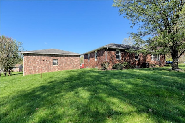 exterior space with a yard and brick siding