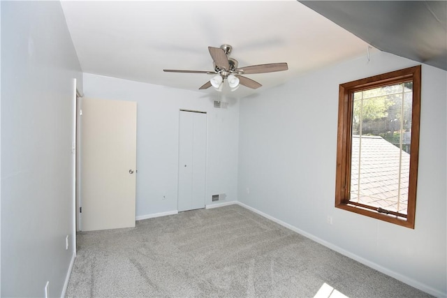 interior space featuring baseboards, ceiling fan, carpet flooring, and visible vents