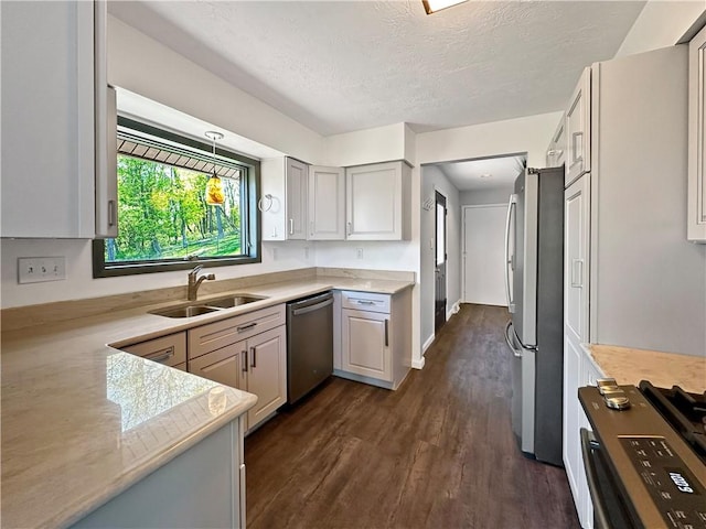 42 Elmhurst St, Green Tree, PA 15220 - kitchen with a textured ceiling, appliances with stainless steel finishes, a sink, and dark wood-type flooring