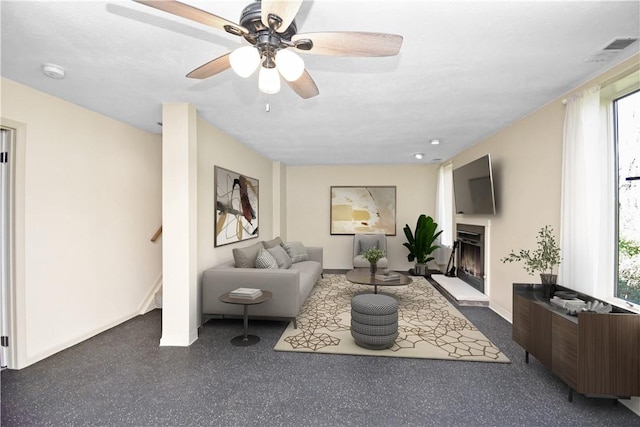 42 Elmhurst St, Green Tree, PA 15220 - living room featuring baseboards, a fireplace with raised hearth, stairs, and a ceiling fan