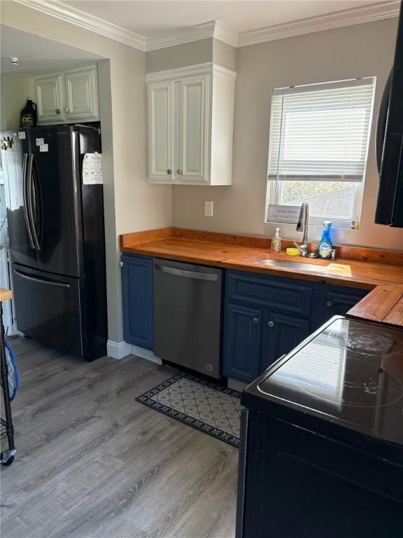 kitchen featuring light wood-type flooring, blue cabinets, wood counters, and black appliances