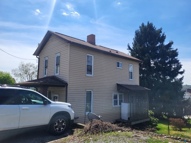 view of side of property featuring a chimney