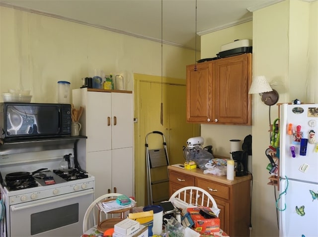 kitchen featuring crown molding, brown cabinetry, and white appliances