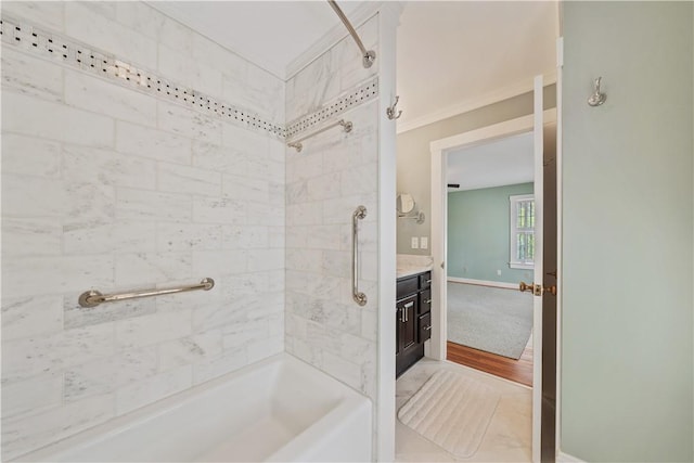 bathroom with baseboards, ornamental molding, washtub / shower combination, and vanity