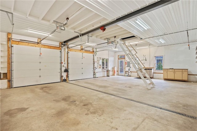 garage with a garage door opener and electric panel