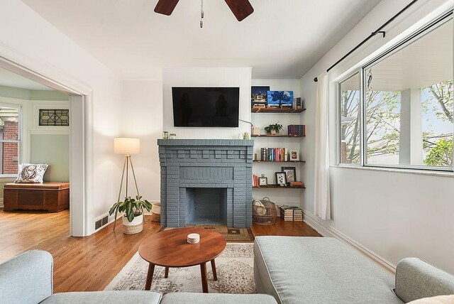961 Deely St, Greenfield, PA 15217 - living area with ceiling fan, a fireplace, baseboards, wood finished floors, and visible vents