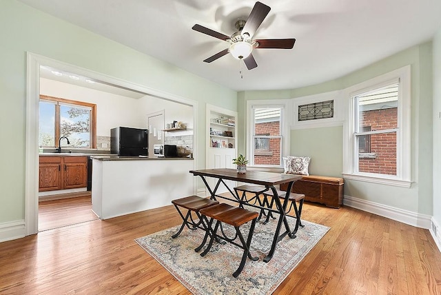 961 Deely St, Greenfield, PA 15217 - dining room featuring baseboards, ceiling fan, a healthy amount of sunlight, and light wood-style floors