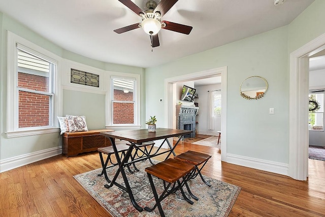 961 Deely St, Greenfield, PA 15217 - dining room with baseboards, ceiling fan, light wood finished floors, and a stone fireplace