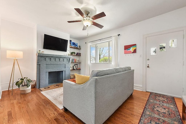 961 Deely St, Greenfield, PA 15217 - living area with baseboards, a ceiling fan, wood finished floors, and a brick fireplace