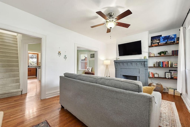961 Deely St, Greenfield, PA 15217 - living area featuring a ceiling fan, stairs, wood finished floors, and a fireplace