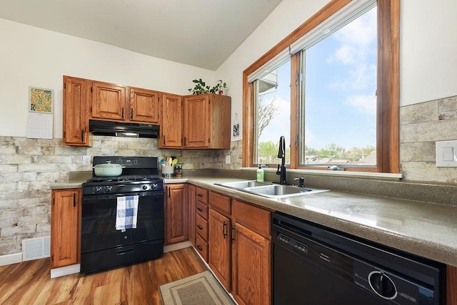 961 Deely St, Greenfield, PA 15217 - kitchen featuring brown cabinetry, a sink, black appliances, under cabinet range hood, and light wood-style flooring