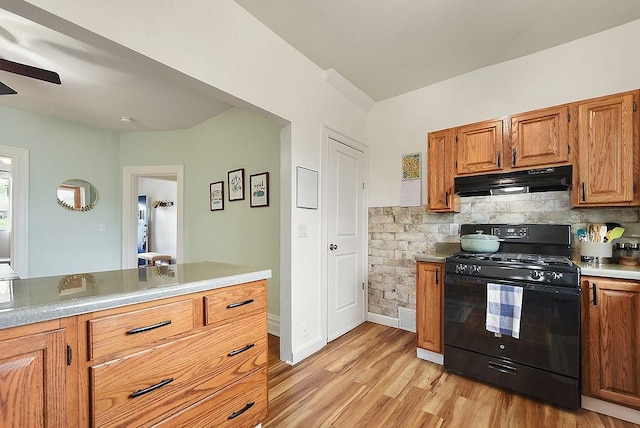 961 Deely St, Greenfield, PA 15217 - kitchen with decorative backsplash, ceiling fan, black gas range, light wood-style floors, and under cabinet range hood