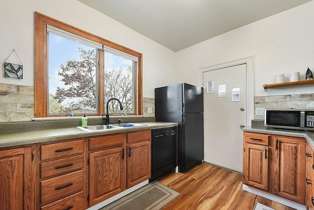 961 Deely St, Greenfield, PA 15217 - kitchen featuring brown cabinetry, decorative backsplash, a sink, and black appliances