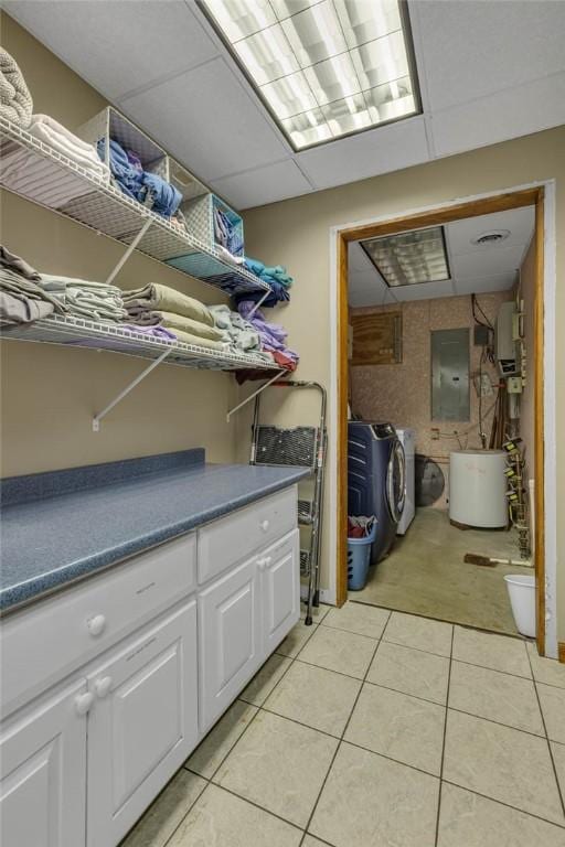 laundry room with light tile patterned floors, laundry area, electric panel, and washing machine and clothes dryer