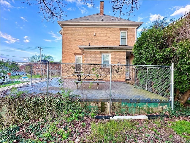 1102 E Washington St, New Castle/4Th, PA 16101 - back of house with fence, a patio, a chimney, and brick siding