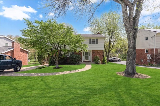 61 Norfolk Dr, Robinson Twp Nwa, PA 15108 - obstructed view of property with brick siding, a chimney, and a front lawn