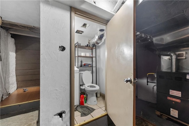 bathroom featuring toilet and tile patterned flooring