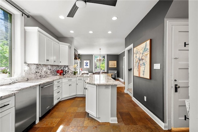 kitchen with stainless steel dishwasher, a ceiling fan, recessed lighting, and white cabinetry