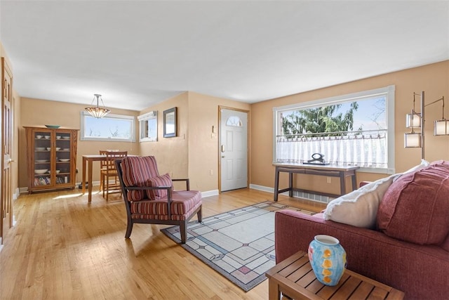 living room with baseboards and light wood finished floors