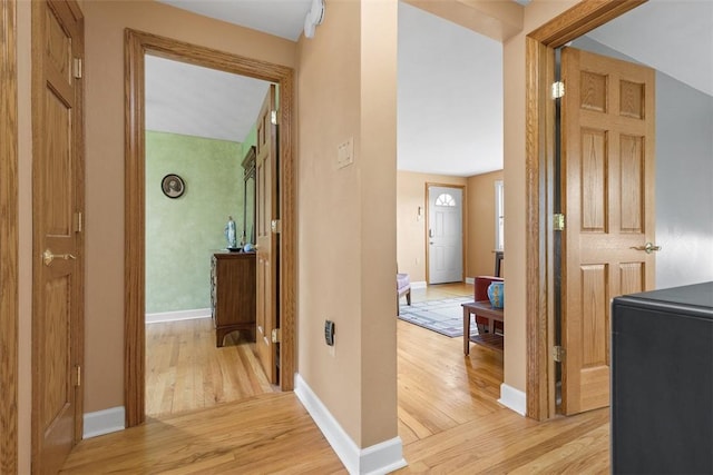 hall featuring baseboards and light wood-style flooring