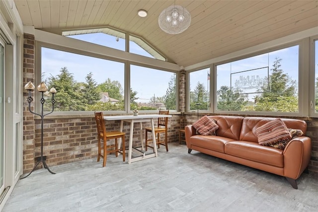 sunroom / solarium with wood ceiling, wood finished floors, and vaulted ceiling