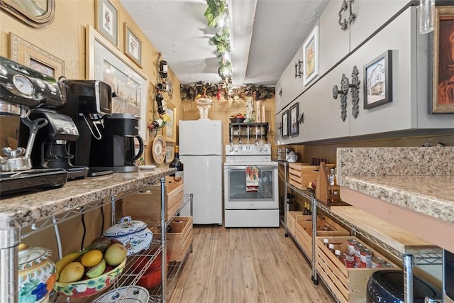kitchen with light countertops, white appliances, and light wood-style flooring